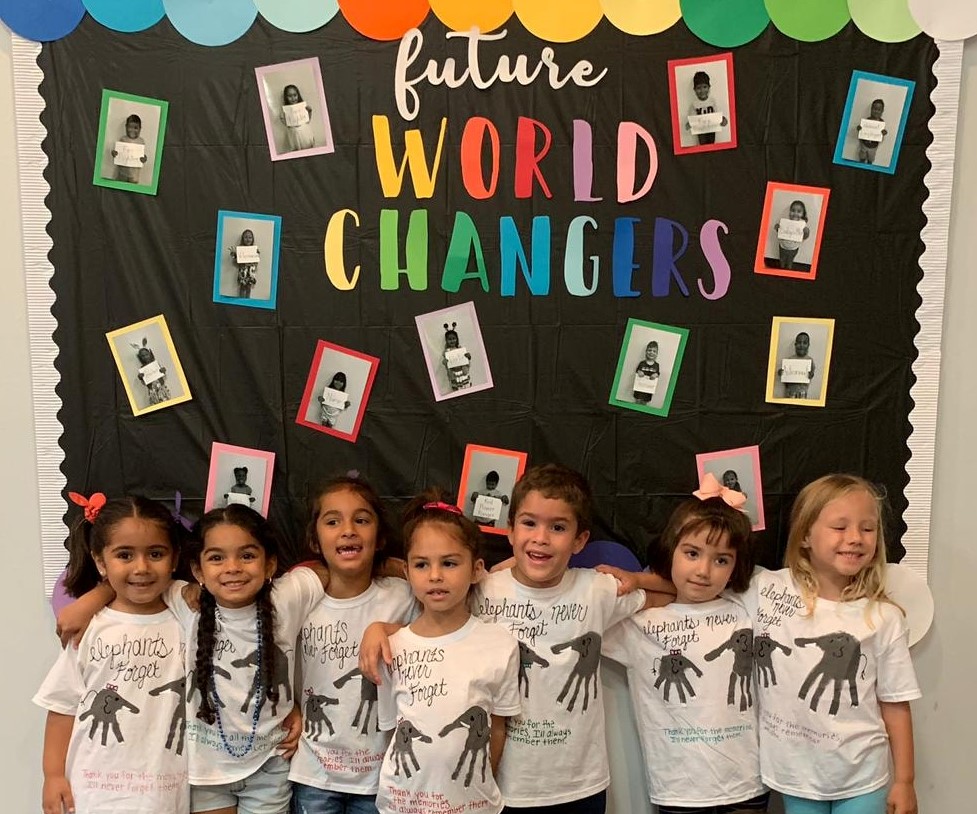 Children in front of Future World Changers poster at Daycare.